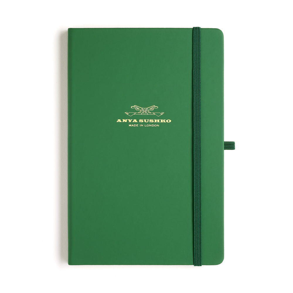 A green hardback A5 refill Luxury notepad with a ribbon bookmark and elastic pen holder, featuring the Anya Sushko brand logo embossed in gold at the front.