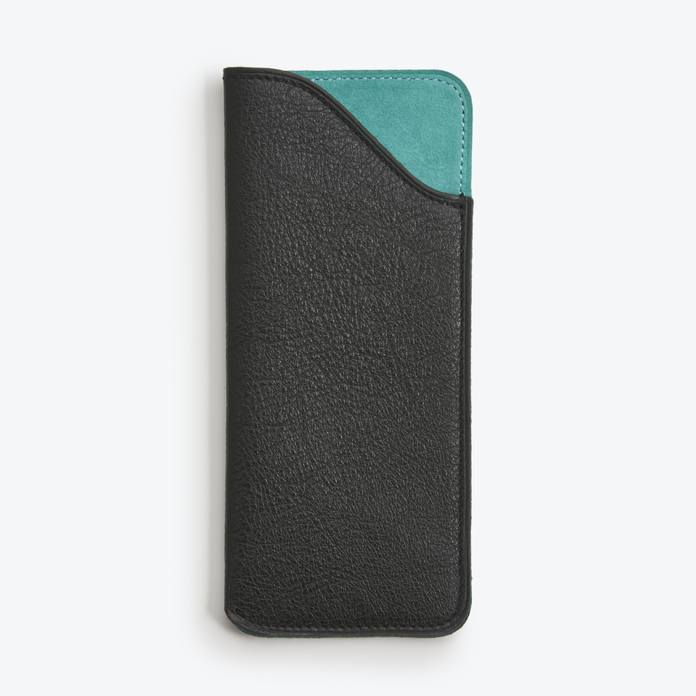 Luxury leather glasses case Black and Turquoise with a green suede lining, closed and standing upright.