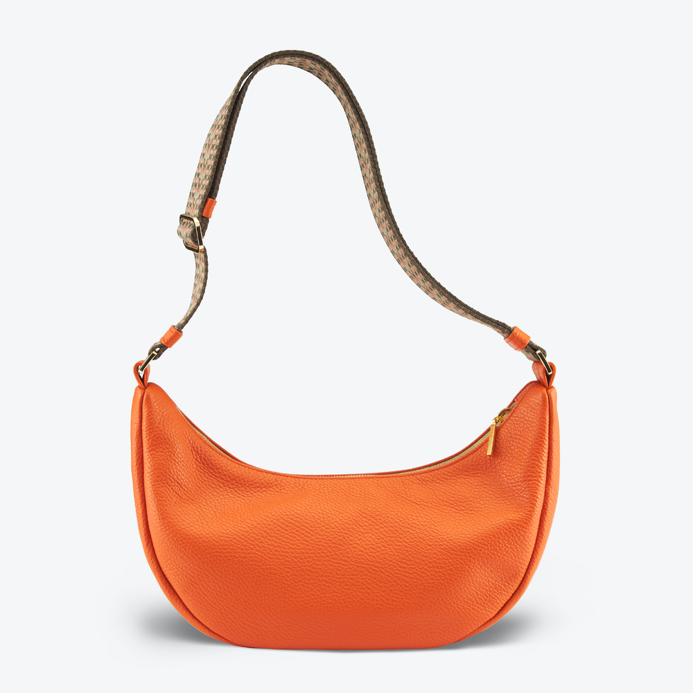 Luxury crossbody bag handbag Navy Blue with a brown strap on a light gray 