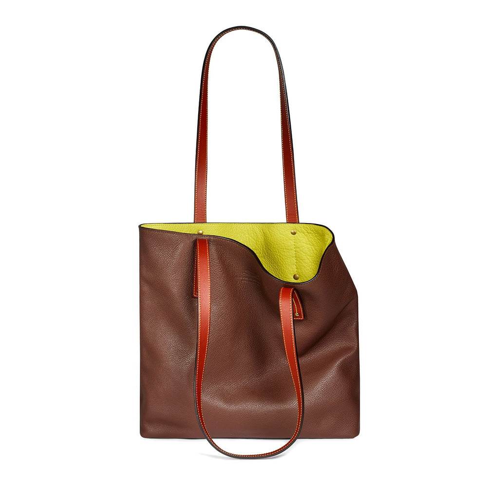 Luxury brown-and-yellow leather tote bag with white background